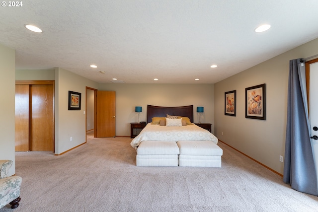 carpeted bedroom featuring a textured ceiling