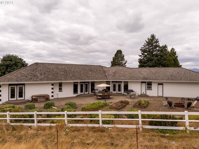 view of front of house with a patio area and french doors