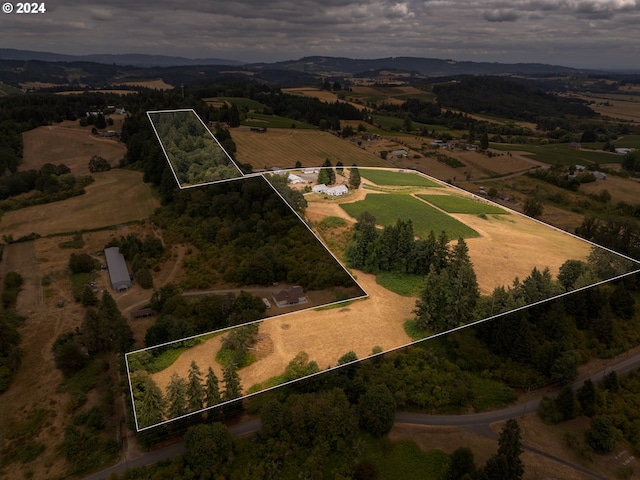 birds eye view of property with a rural view