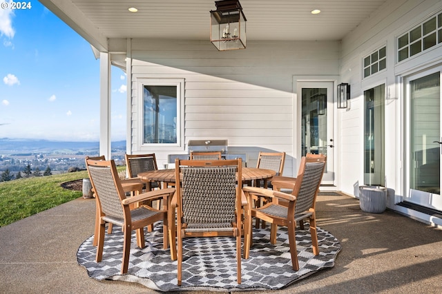 view of patio / terrace with a mountain view and grilling area