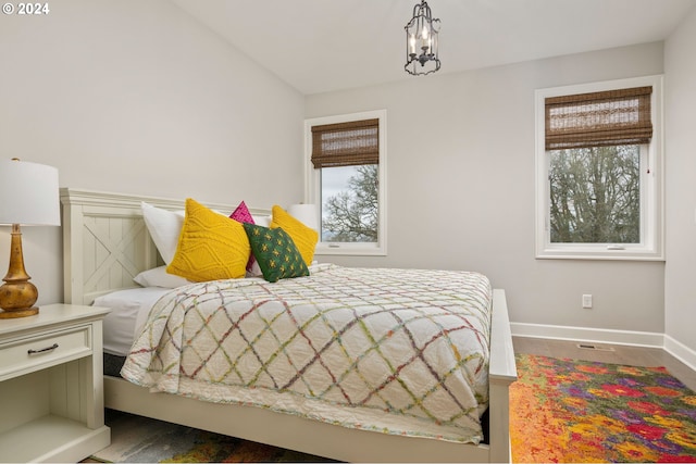 bedroom featuring lofted ceiling and multiple windows