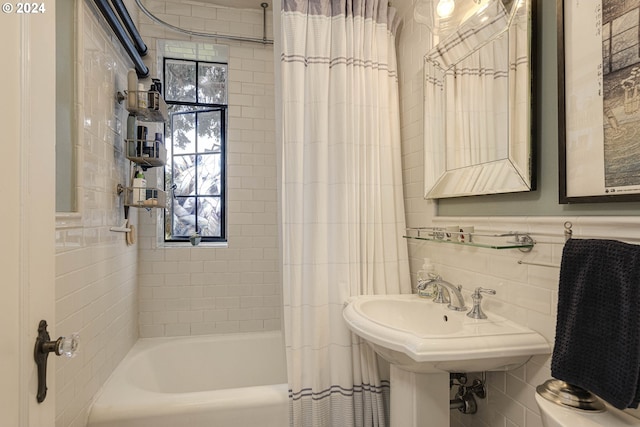 bathroom featuring shower / tub combo with curtain and tile walls