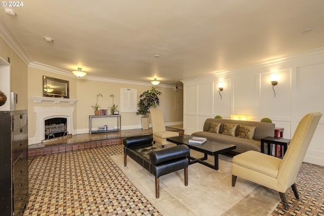 living room with crown molding, a fireplace with raised hearth, and a decorative wall