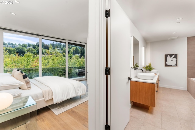 bedroom featuring light hardwood / wood-style flooring and sink