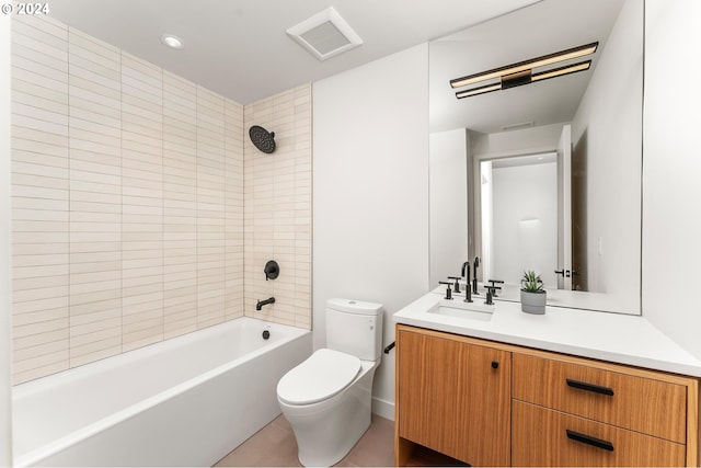 full bathroom featuring tile patterned floors, tiled shower / bath combo, vanity, and toilet