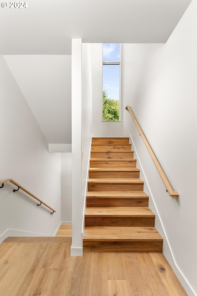 stairs with baseboards and wood finished floors