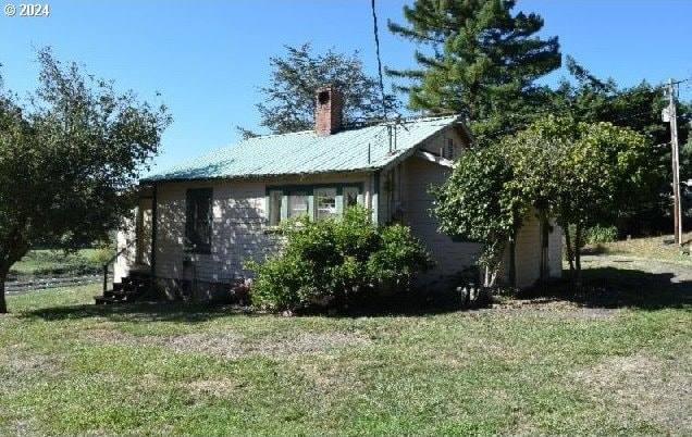 view of home's exterior with a yard