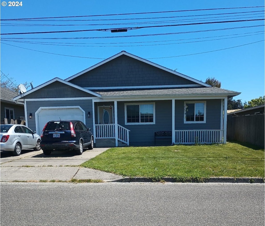 view of front of house with a garage and a front lawn