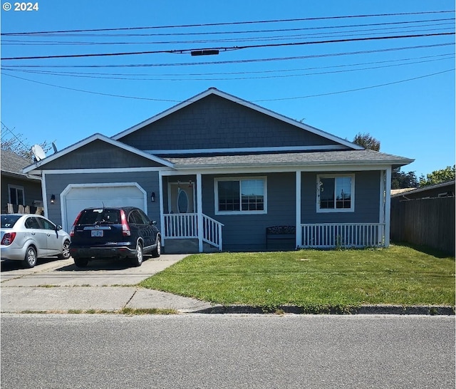 view of front of house with a garage and a front lawn