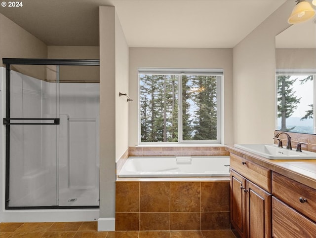 bathroom with tile patterned floors, separate shower and tub, and vanity