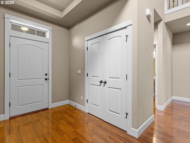 entrance foyer with a textured ceiling and light wood-type flooring