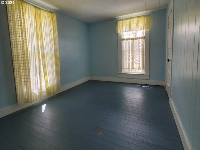 empty room with dark wood-type flooring