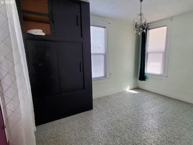 foyer with plenty of natural light and a notable chandelier