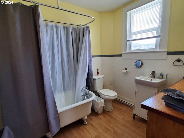 full bathroom featuring vanity, toilet, wood-type flooring, and shower / tub combo