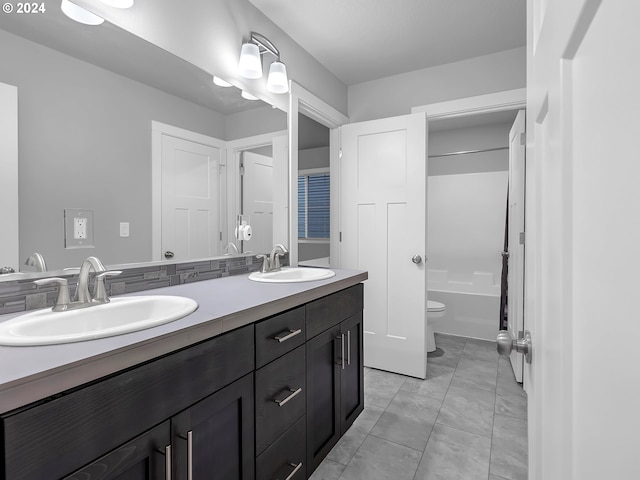 full bathroom with tile patterned flooring, vanity, toilet, and shower / washtub combination