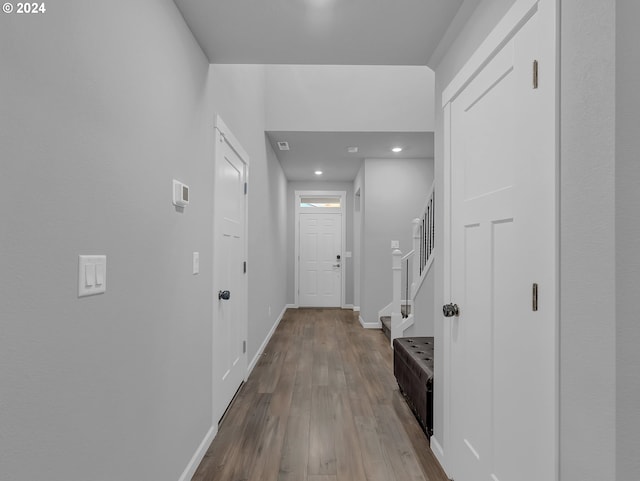 corridor with light hardwood / wood-style floors