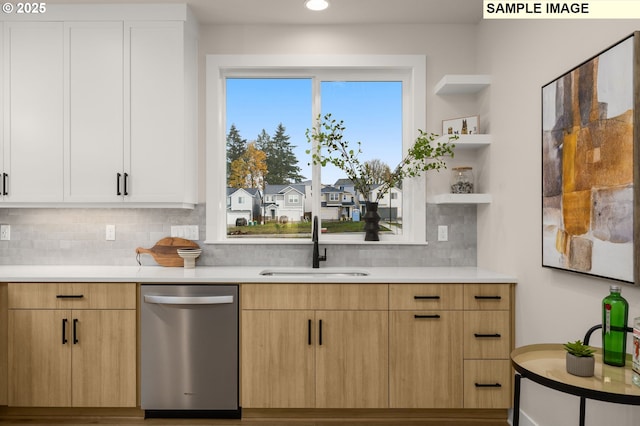 kitchen featuring a sink, open shelves, light countertops, and stainless steel dishwasher