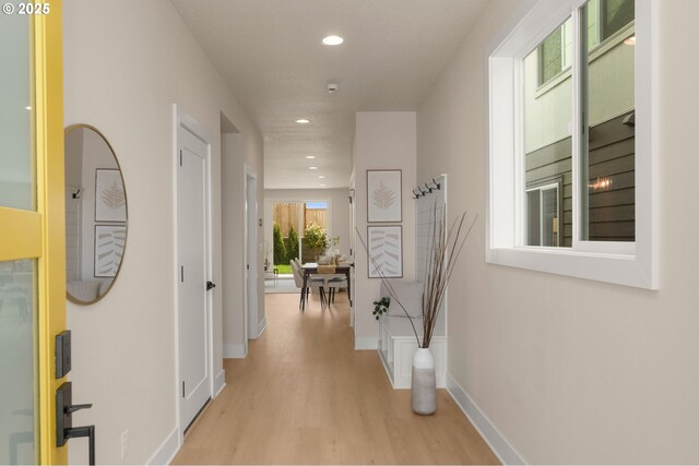 kitchen with a sink, open shelves, tasteful backsplash, light countertops, and stainless steel dishwasher