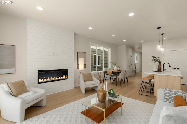 12040 SW Trask St Unit Lt96, Beaverton, OR 97007 - living area featuring light wood-type flooring, a fireplace, recessed lighting, and baseboards