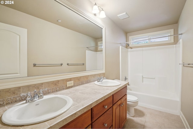 full bathroom with bathtub / shower combination, decorative backsplash, tile patterned floors, vanity, and toilet