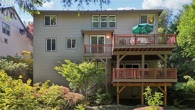 back of house featuring a wooden deck