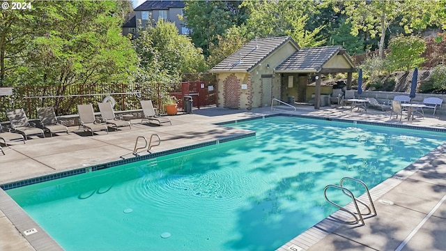 view of swimming pool featuring a patio area