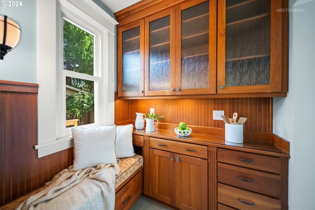 sitting room featuring wooden walls