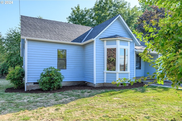 bungalow-style house with a front yard