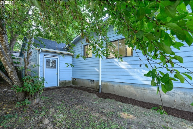 exterior space with a shingled roof