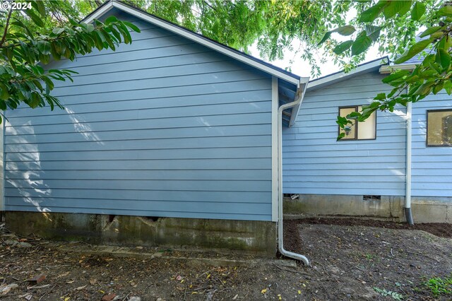 view of side of home with crawl space