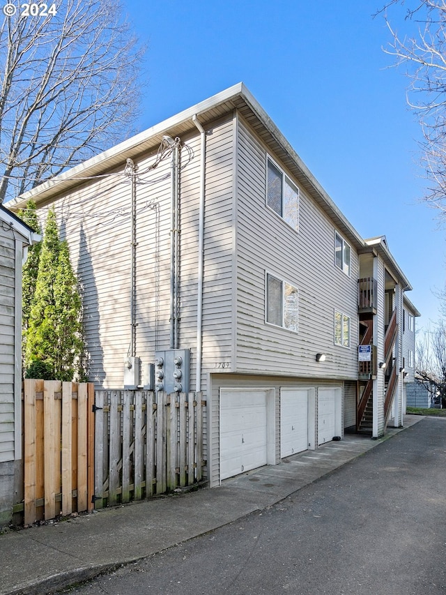 view of home's exterior featuring a balcony and a garage