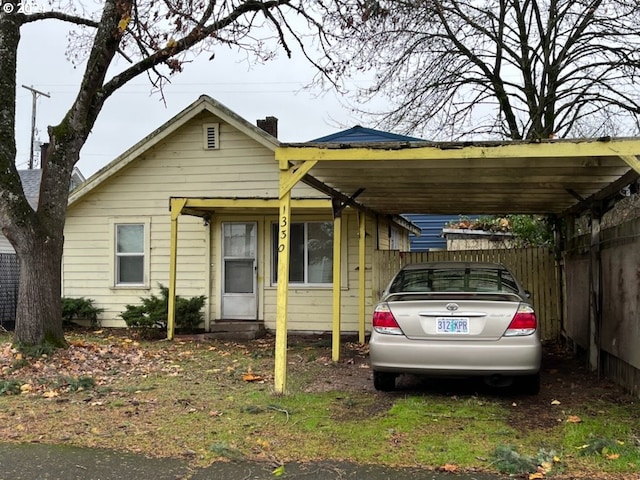 view of front of property featuring a carport