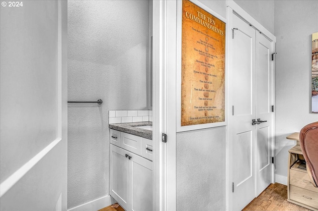 bathroom featuring hardwood / wood-style flooring and vanity