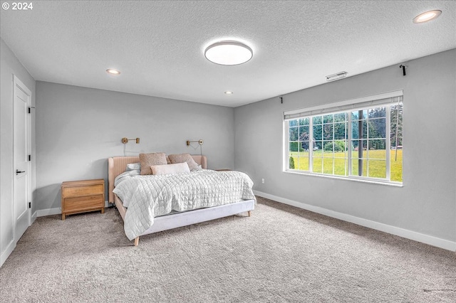 carpeted bedroom with a textured ceiling