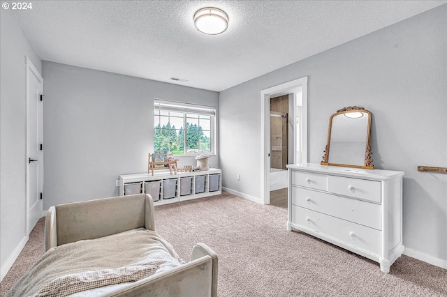 sitting room featuring light colored carpet and a textured ceiling