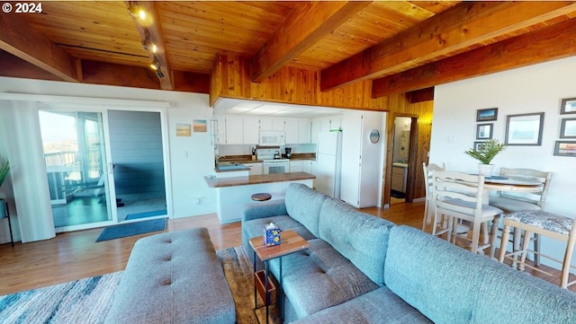 living room featuring beamed ceiling, light hardwood / wood-style floors, track lighting, and wood ceiling