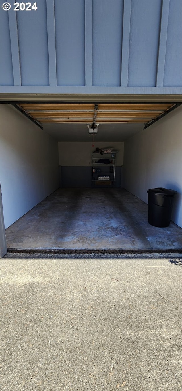 garage featuring a garage door opener and a carport