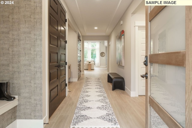 corridor with light hardwood / wood-style floors