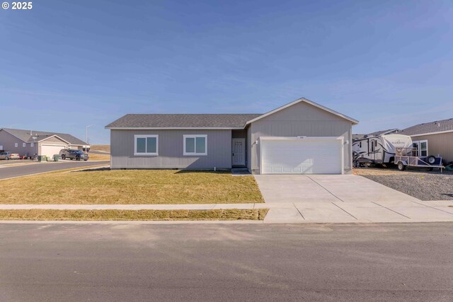 ranch-style home with a garage and a front yard