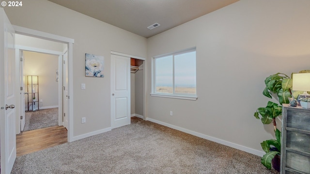 carpeted bedroom with visible vents and baseboards