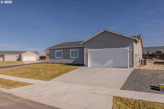 ranch-style home with a garage, driveway, fence, central air condition unit, and a front lawn