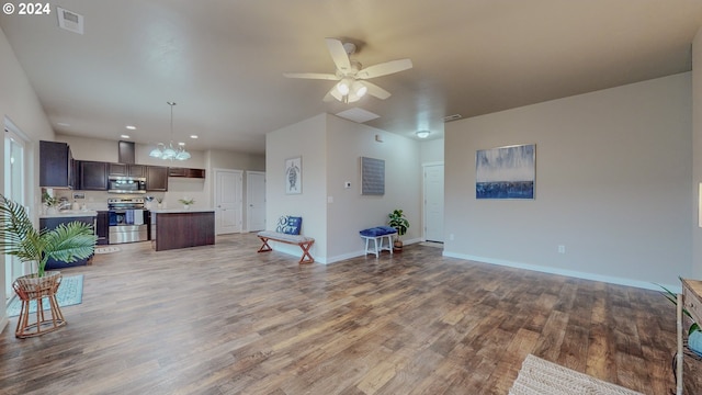 living room featuring light wood finished floors, baseboards, visible vents, and ceiling fan with notable chandelier