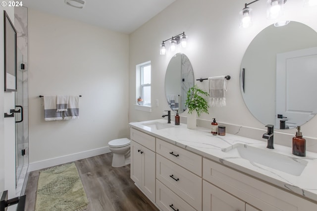 bathroom with walk in shower, vanity, toilet, and hardwood / wood-style flooring