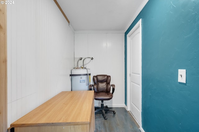 home office with hardwood / wood-style flooring, wood walls, ornamental molding, and water heater