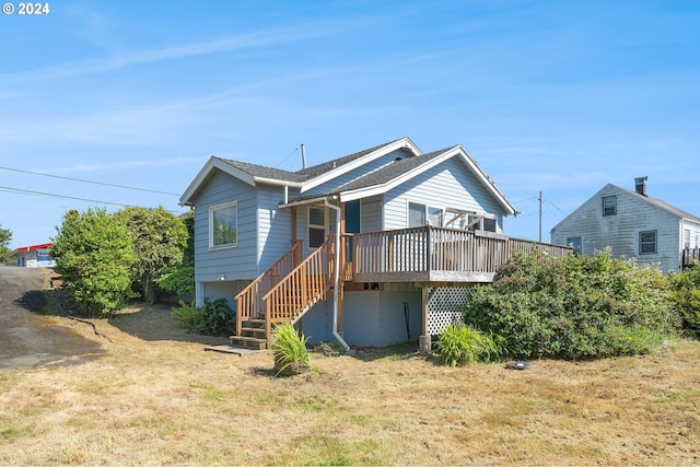 back of house with a lawn and a wooden deck