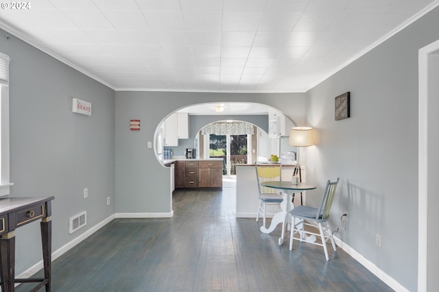 dining room with crown molding and dark hardwood / wood-style flooring