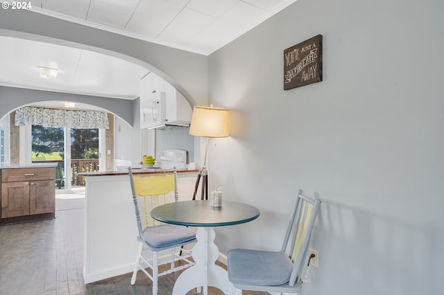 dining room featuring dark wood-type flooring and ornamental molding