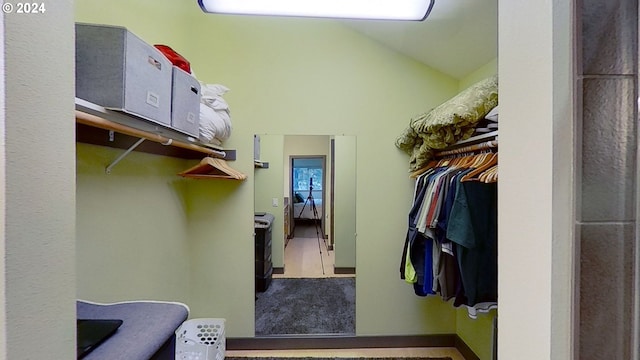 walk in closet featuring lofted ceiling