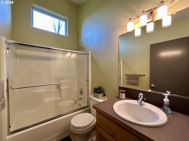 full bathroom featuring vanity, toilet, and enclosed tub / shower combo