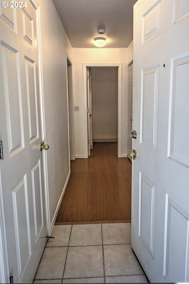 hall featuring light tile patterned floors